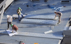 workers installing a new large roof